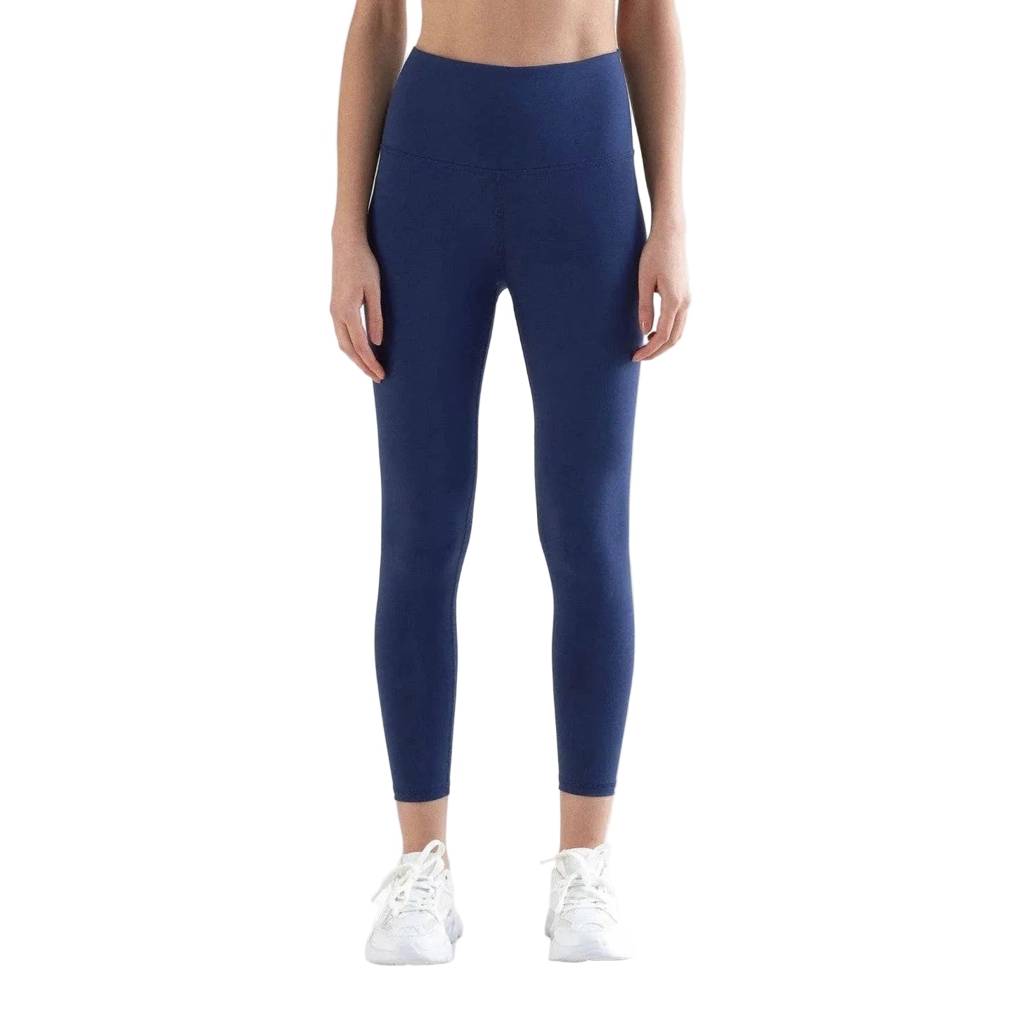 Person wearing navy blue leggings on a white background
