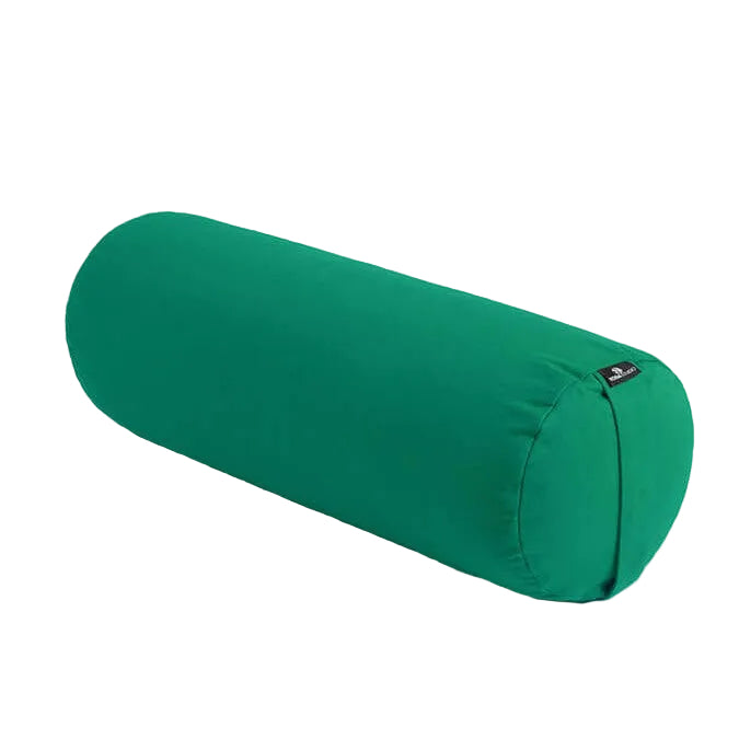 Green cylindrical yoga bolster on a light beige background