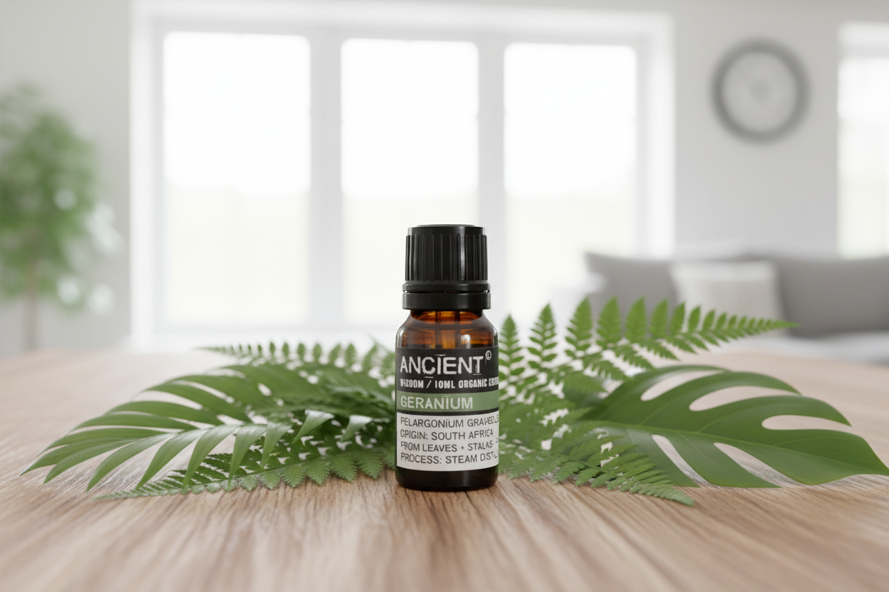 Bottle of essential oil with leaves on a wooden surface