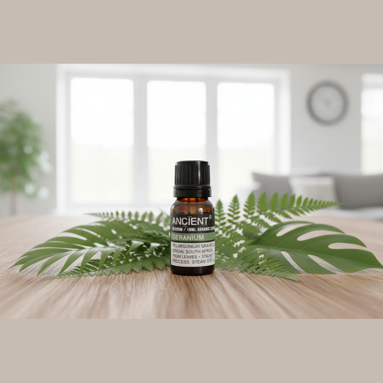Bottle of essential oil with leaves on a wooden surface