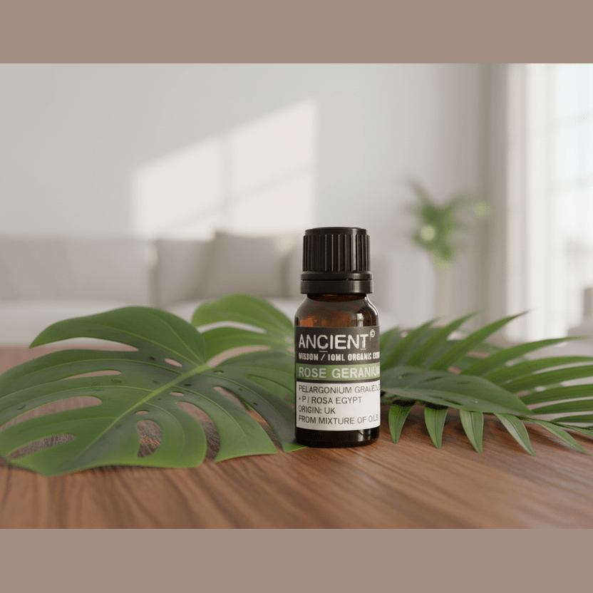 Bottle of 'Ancient Wisdom' organic essential oil with palm leaves on a wooden surface