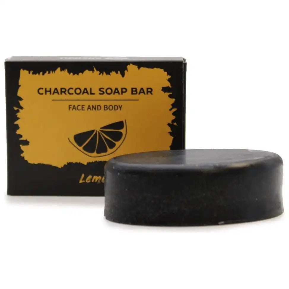 Black lemon charcoal soap bar with packaging on a white background