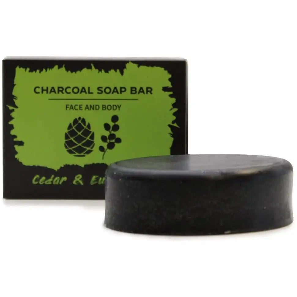 Blackcedar and eucalyptus charcoal soap bar with a green and black packaging label on a white background