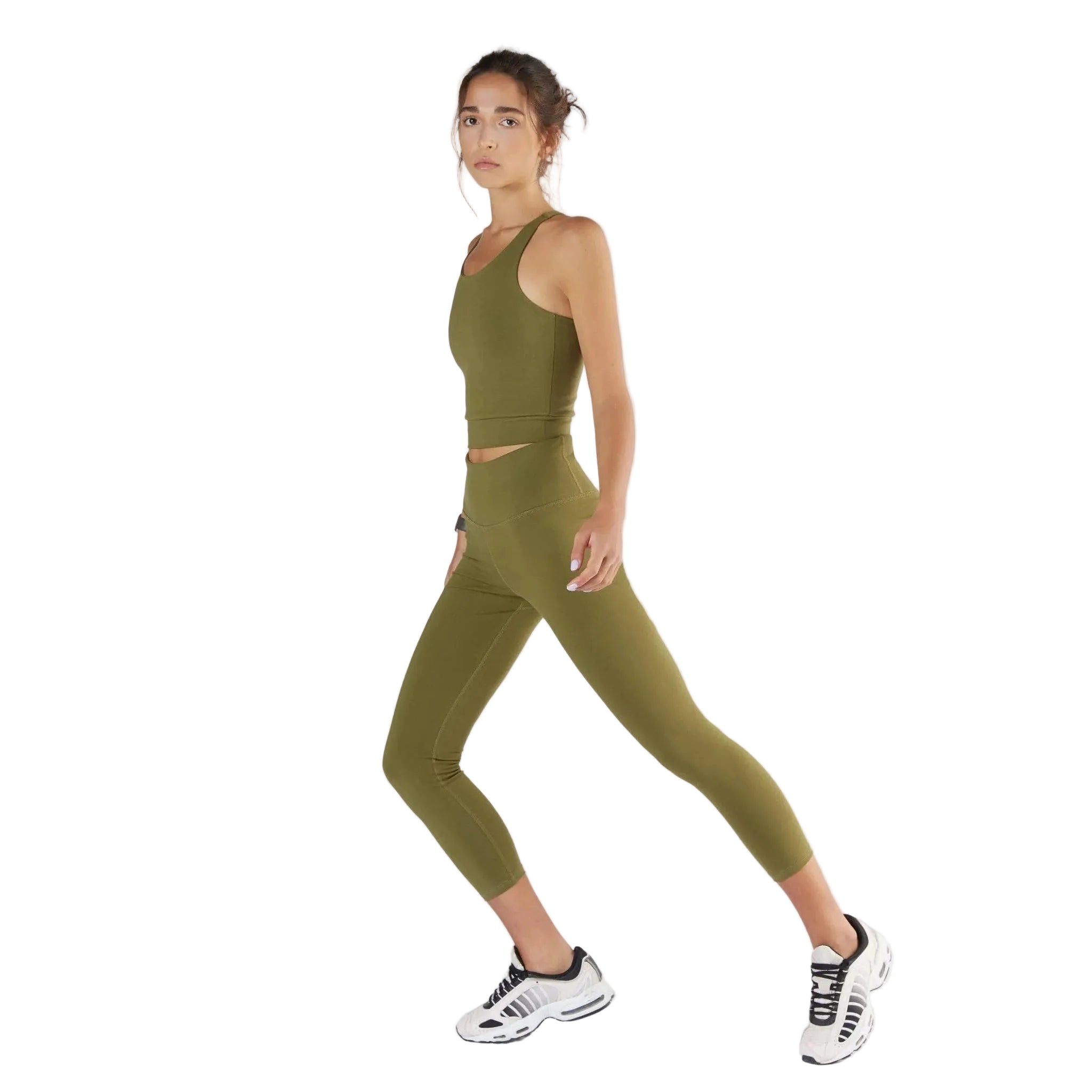 Woman wearing a green athletic outfit on a white background