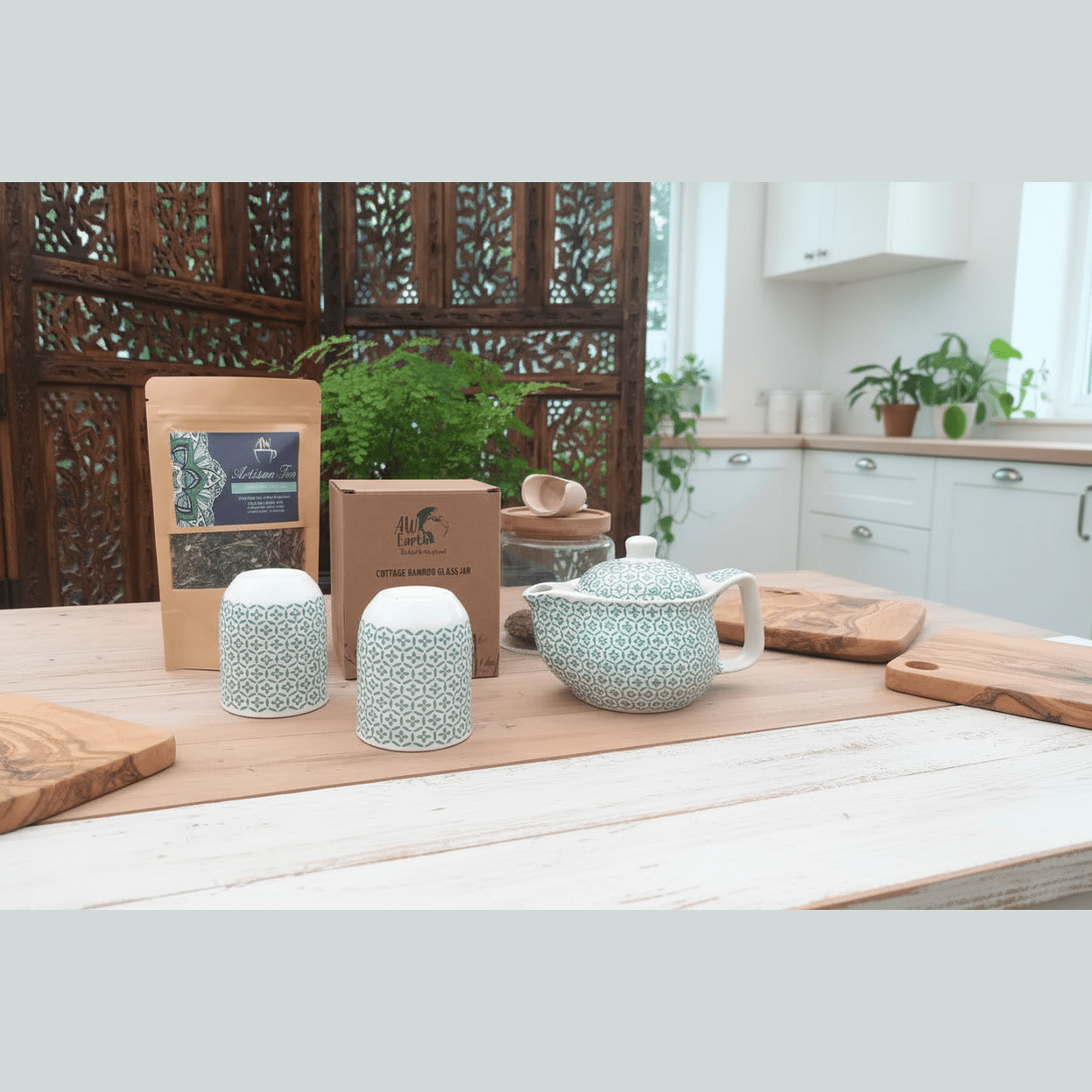 Tea set with green and white pattern on a wooden table in a kitchen setting.