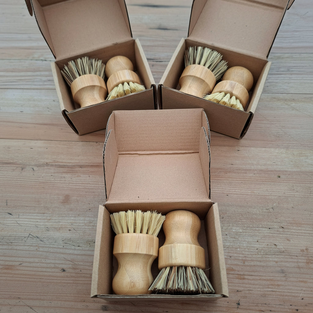 Wooden dish brushes with bristle heads in cardboard boxes on a wooden surface