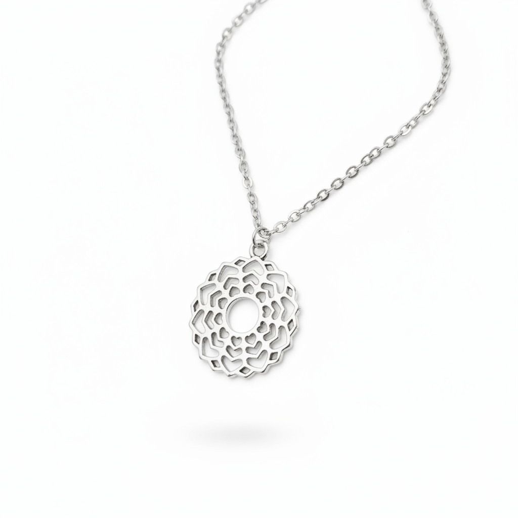 Silver necklace with a intricate pendant on a white background
