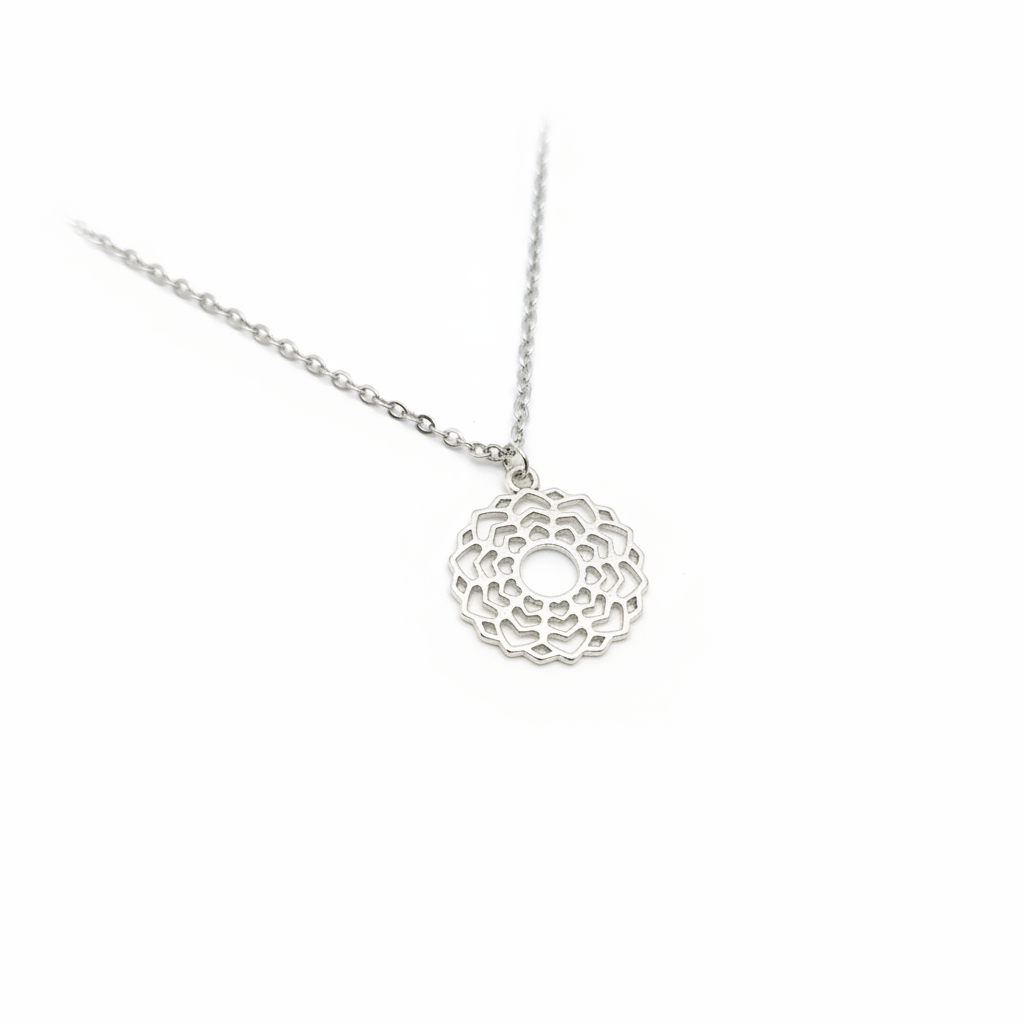 Silver necklace with a intricate pendant on a white background