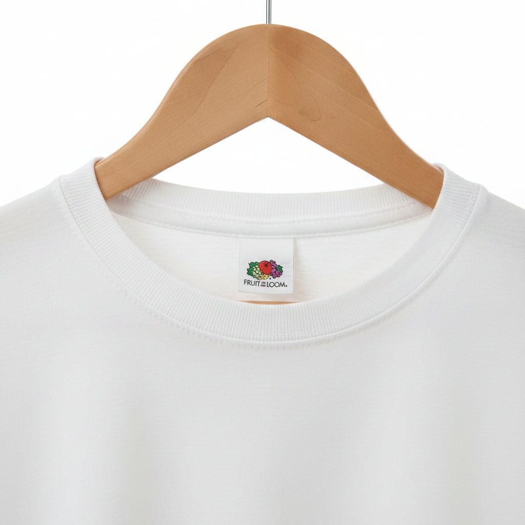 White t-shirt with a brand label on a wooden hanger against a textured background