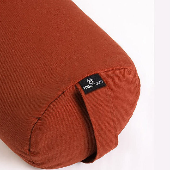 Brown yoga bolster with a visible brand logo on a white background