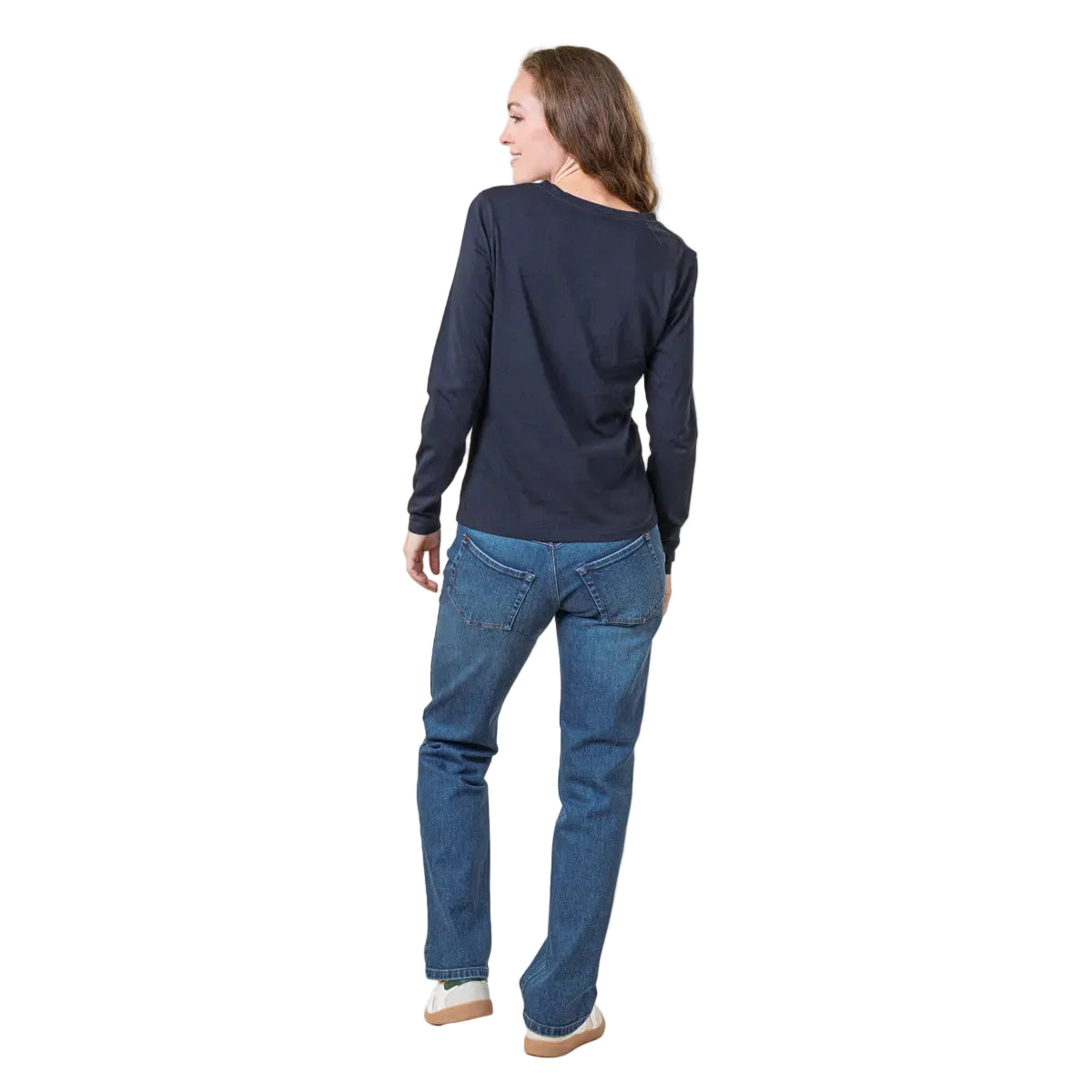 Woman wearing a navy long-sleeve shirt and blue jeans on a white background