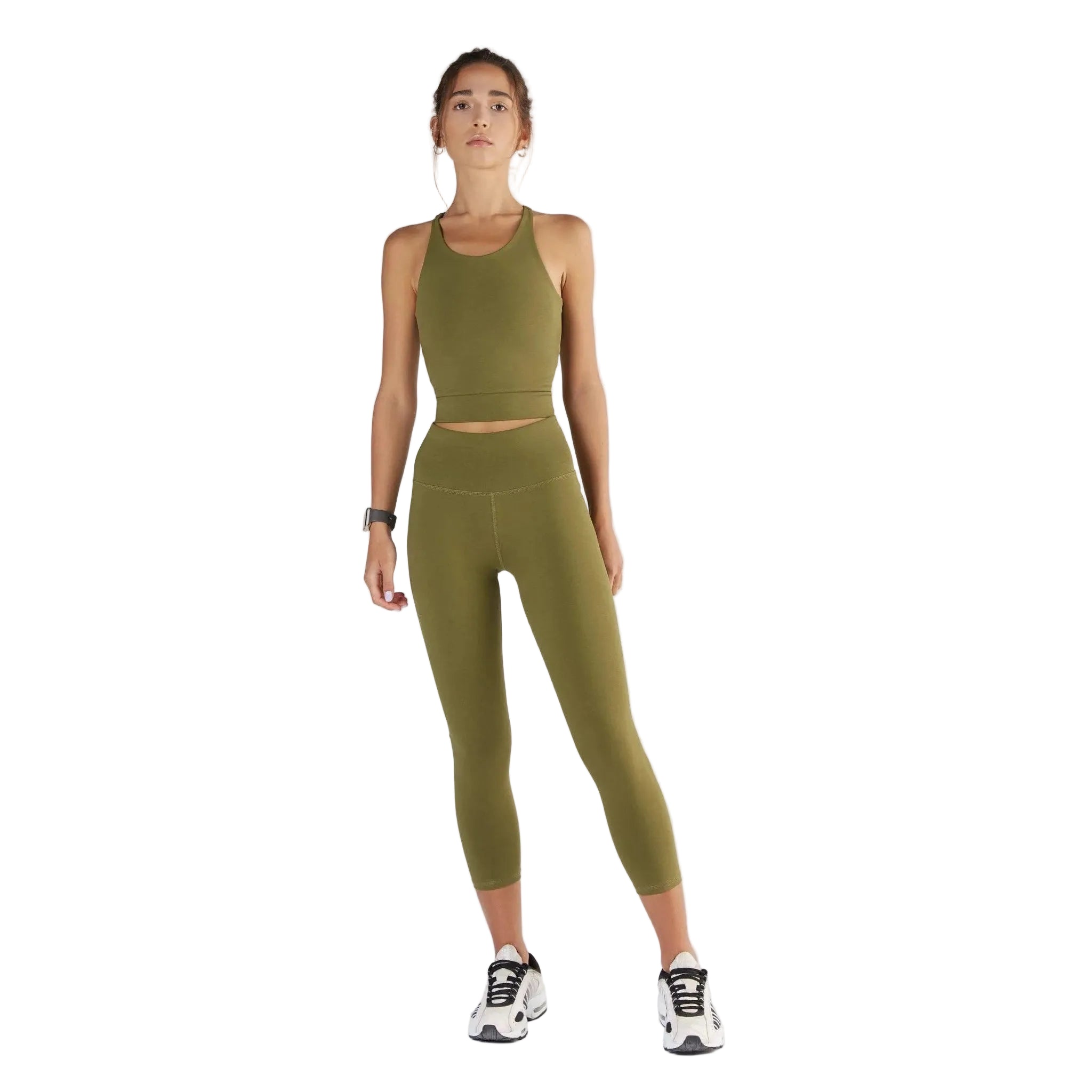 Woman wearing a green athletic outfit on a white background