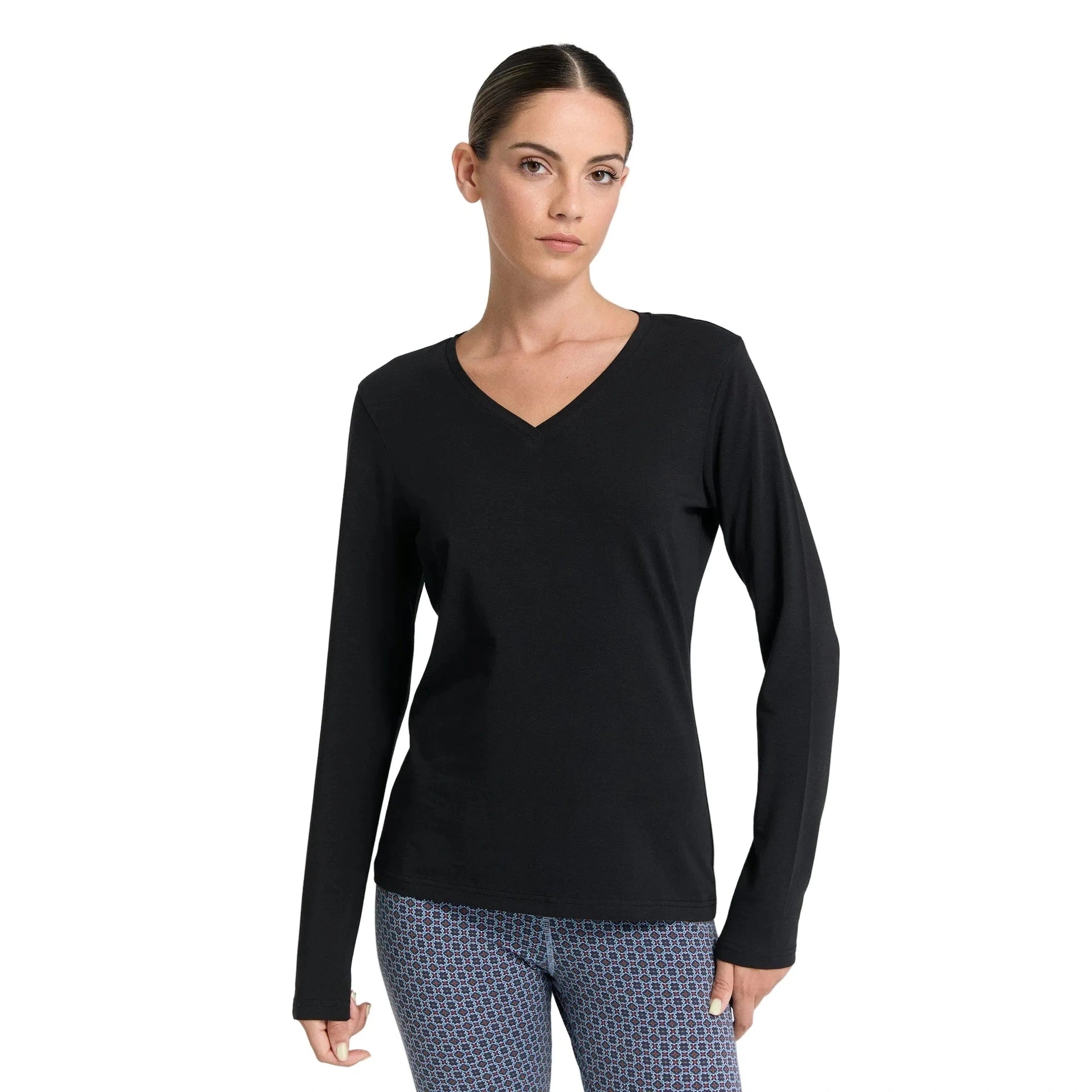 Woman wearing a black long-sleeve top on a white background