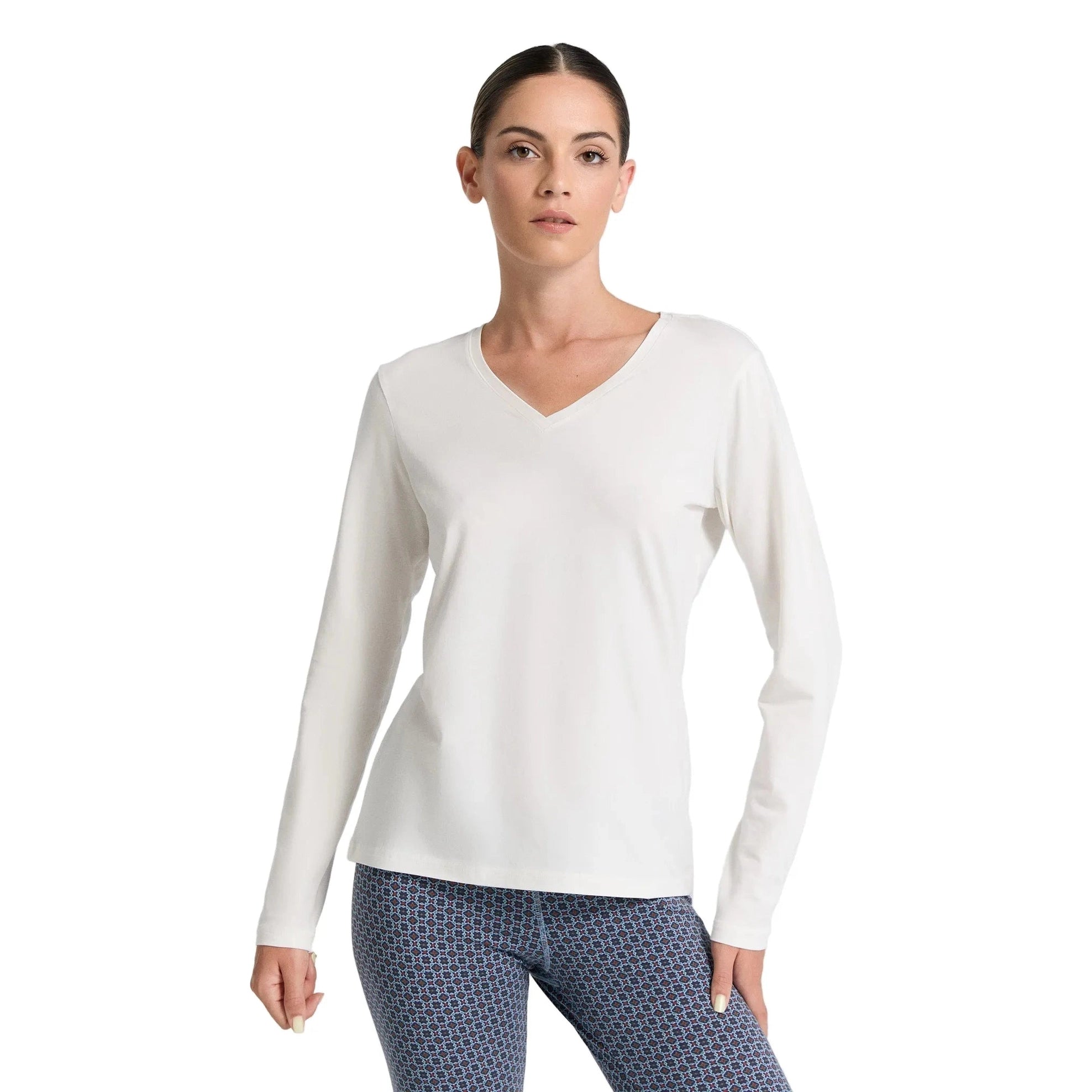 Woman wearing a white long-sleeve shirt on a white background