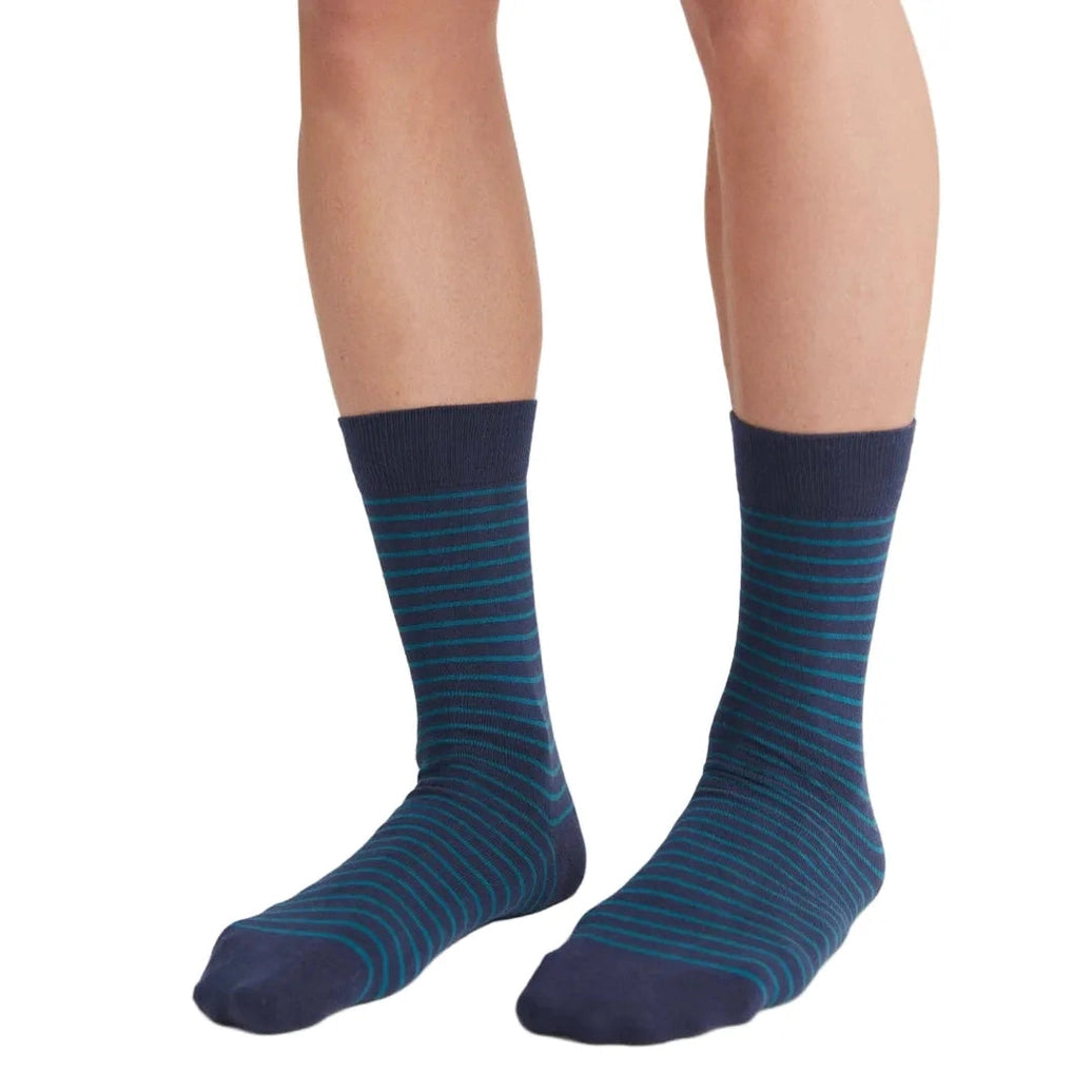 Navy blue striped socks worn by a person on a white background