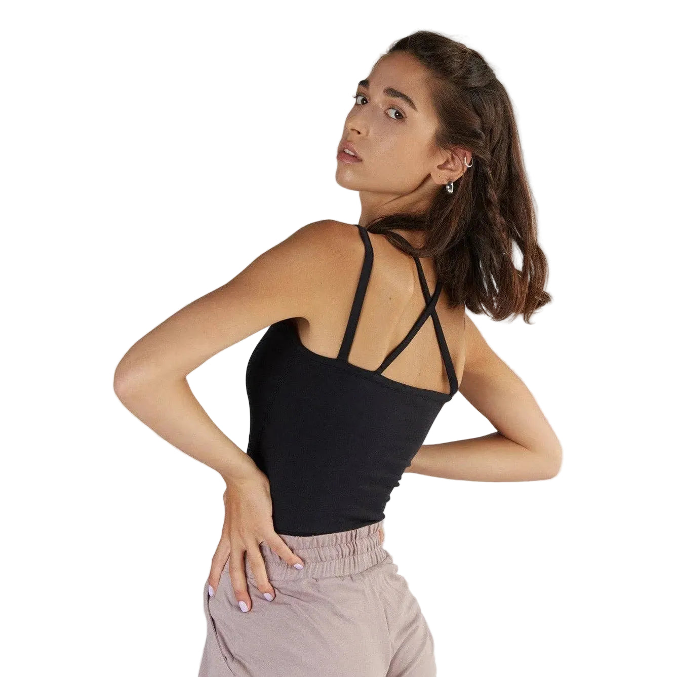 Woman wearing a black tank top with thin straps against a white background