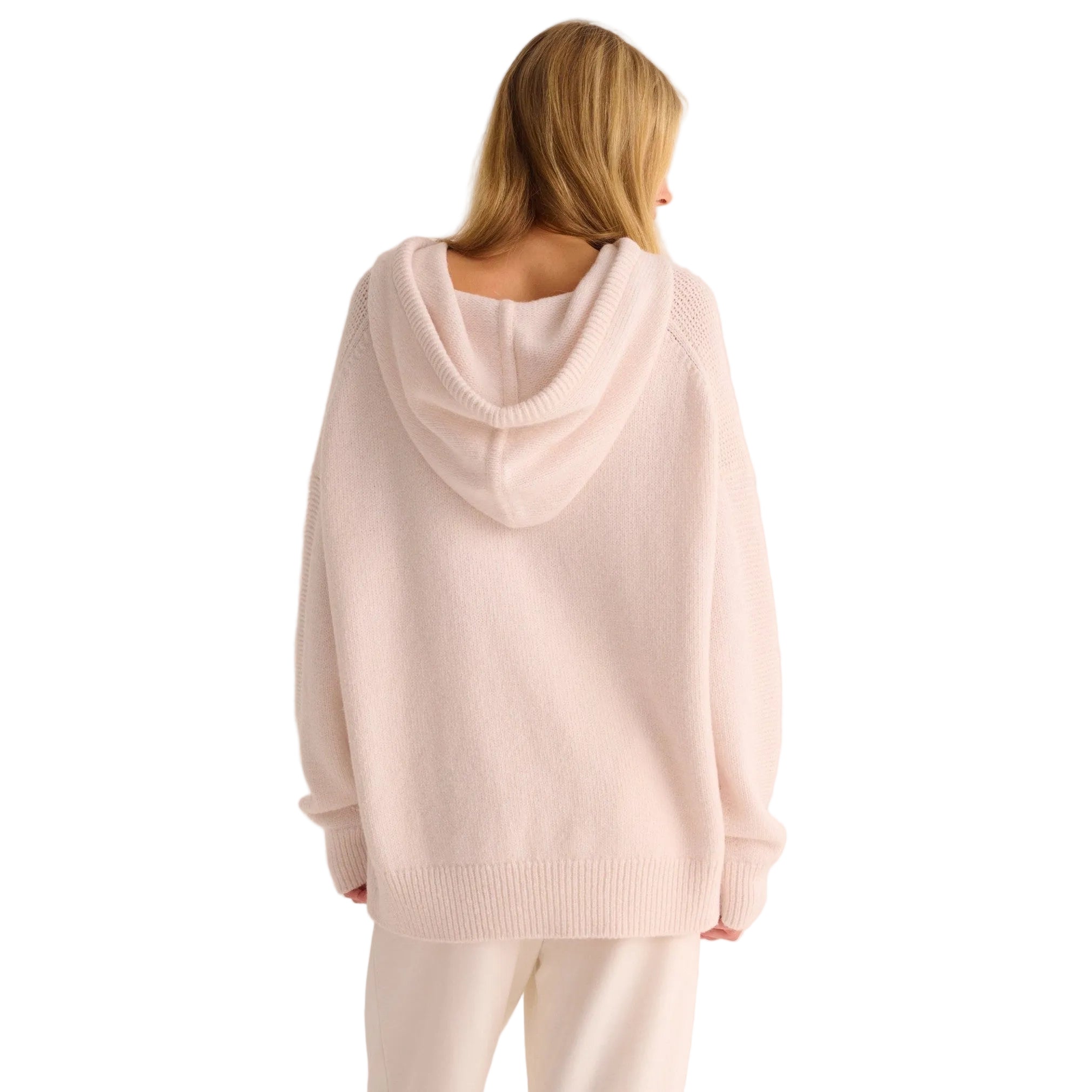 Person wearing an ivory hoodie from behind on a white background