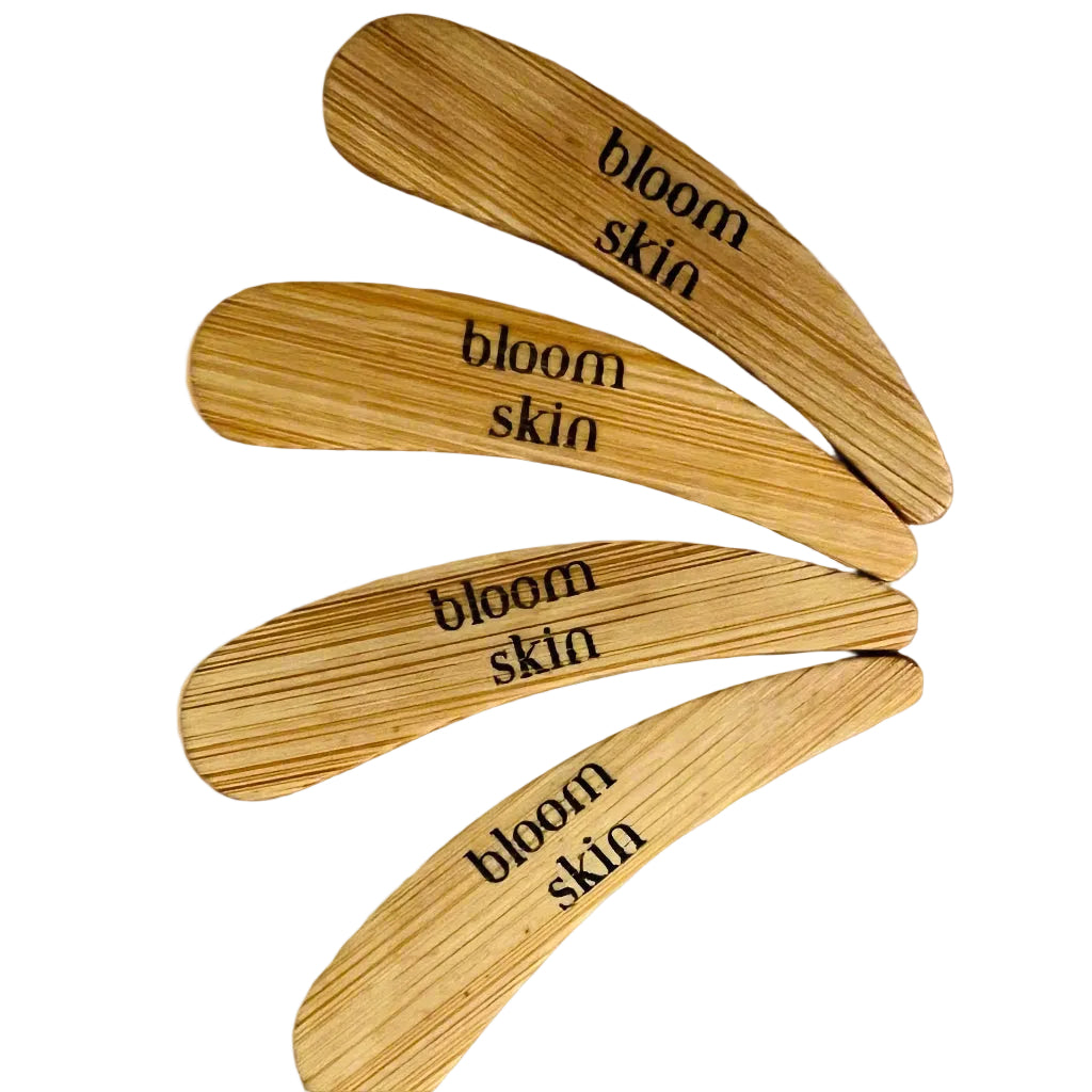 Five wooden spatulas with 'bloom skin' branding on a white background