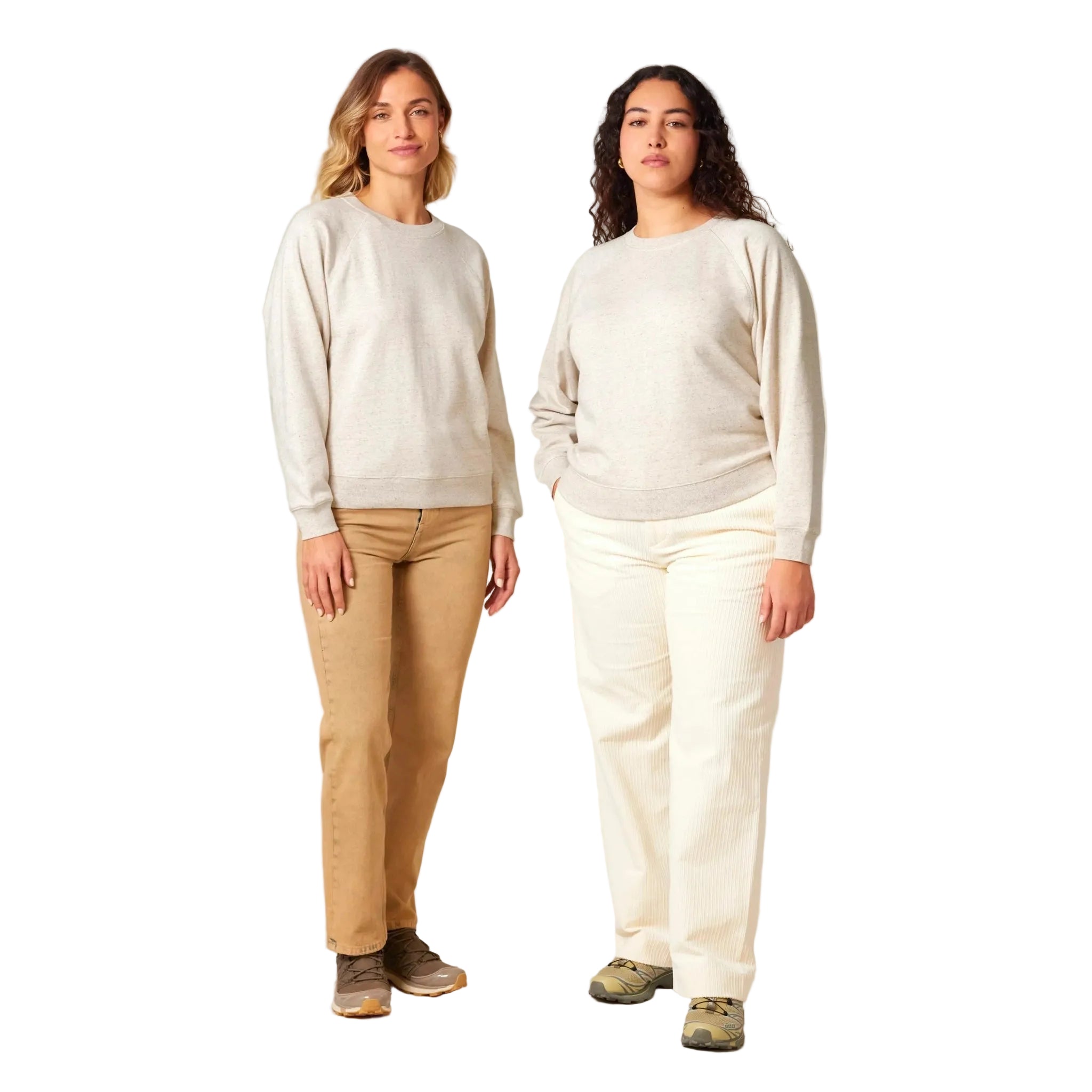 Two women wearing beige and white sweaters with beige and white pants respectively on a plain background