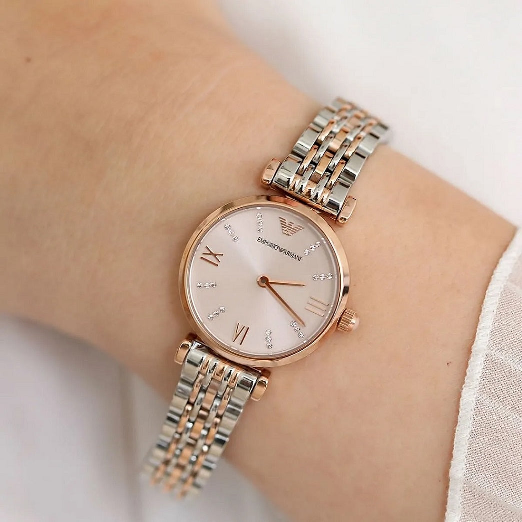 Two-tone watch on a wrist with a light background