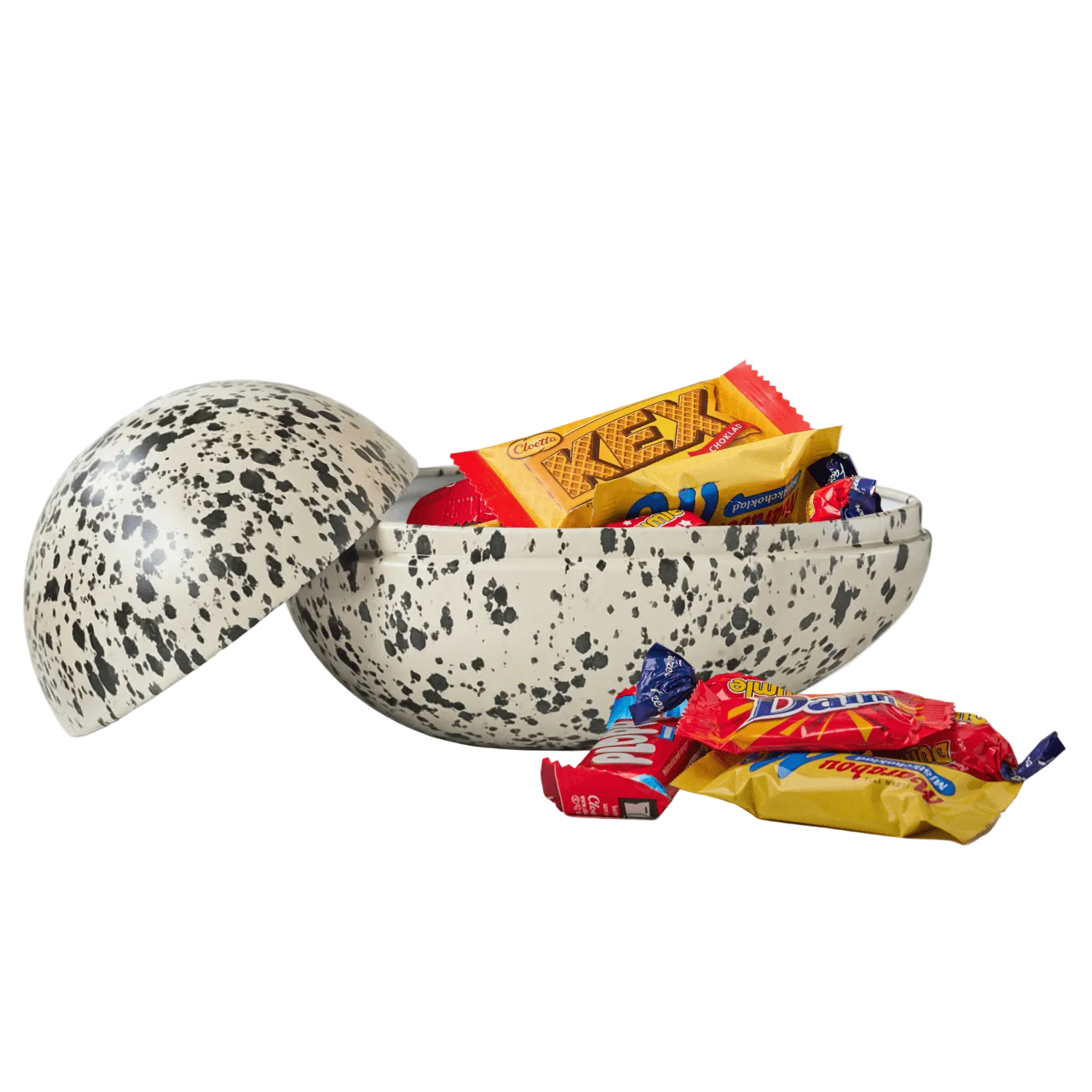 Speckled Easter egg filled with sweets on a white background