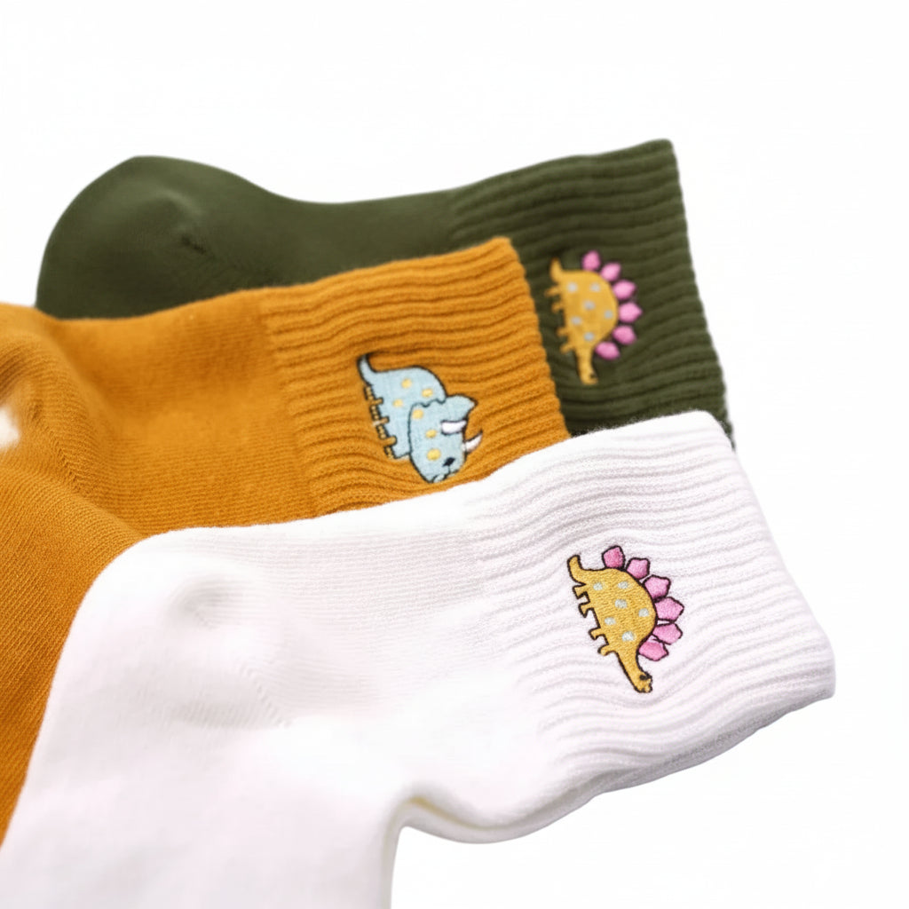 Embroidered dinosaur cotton tube socks, close up of dinosaur embroidery detail - Emmy Jane Boutique