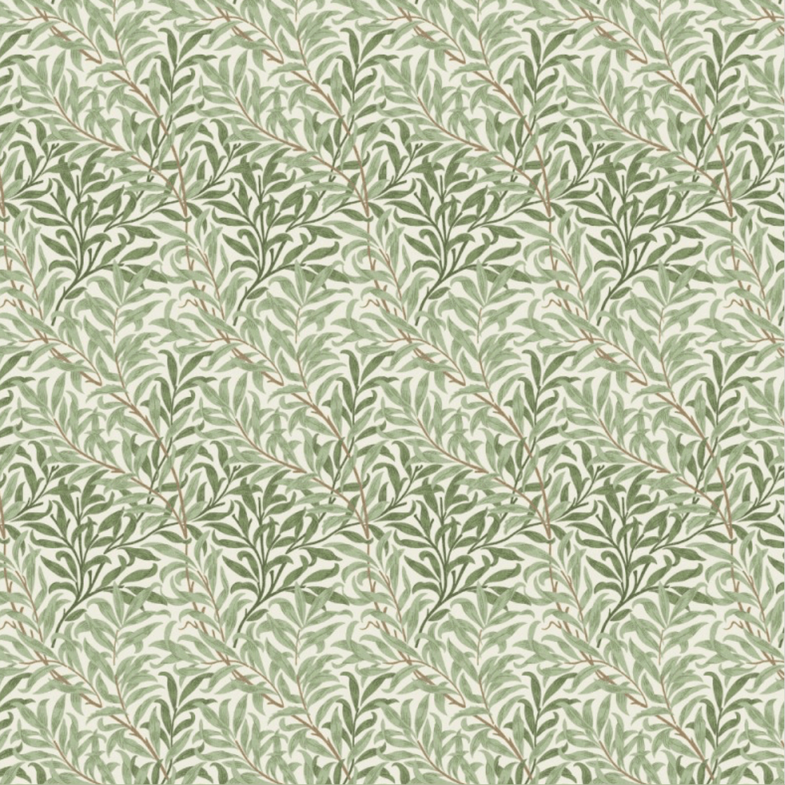 Patterned cotton fabric with leaf design on a light green background