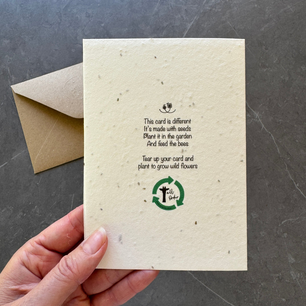Seed paper card with envelope on a dark surface