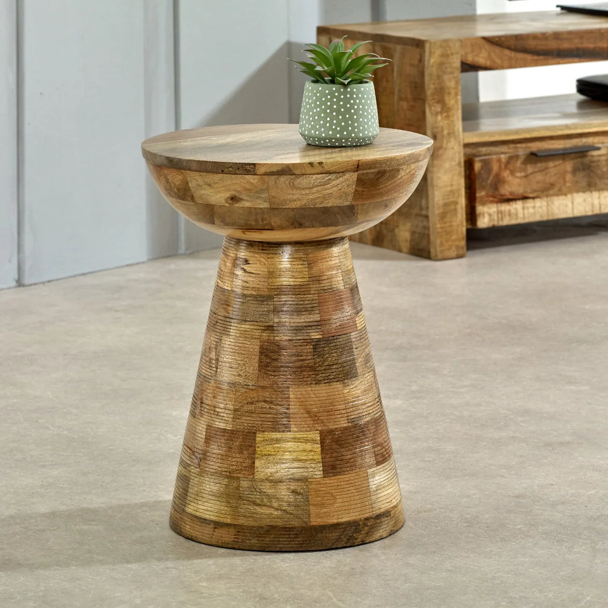 Wooden side table with a plant pot on a neutral background