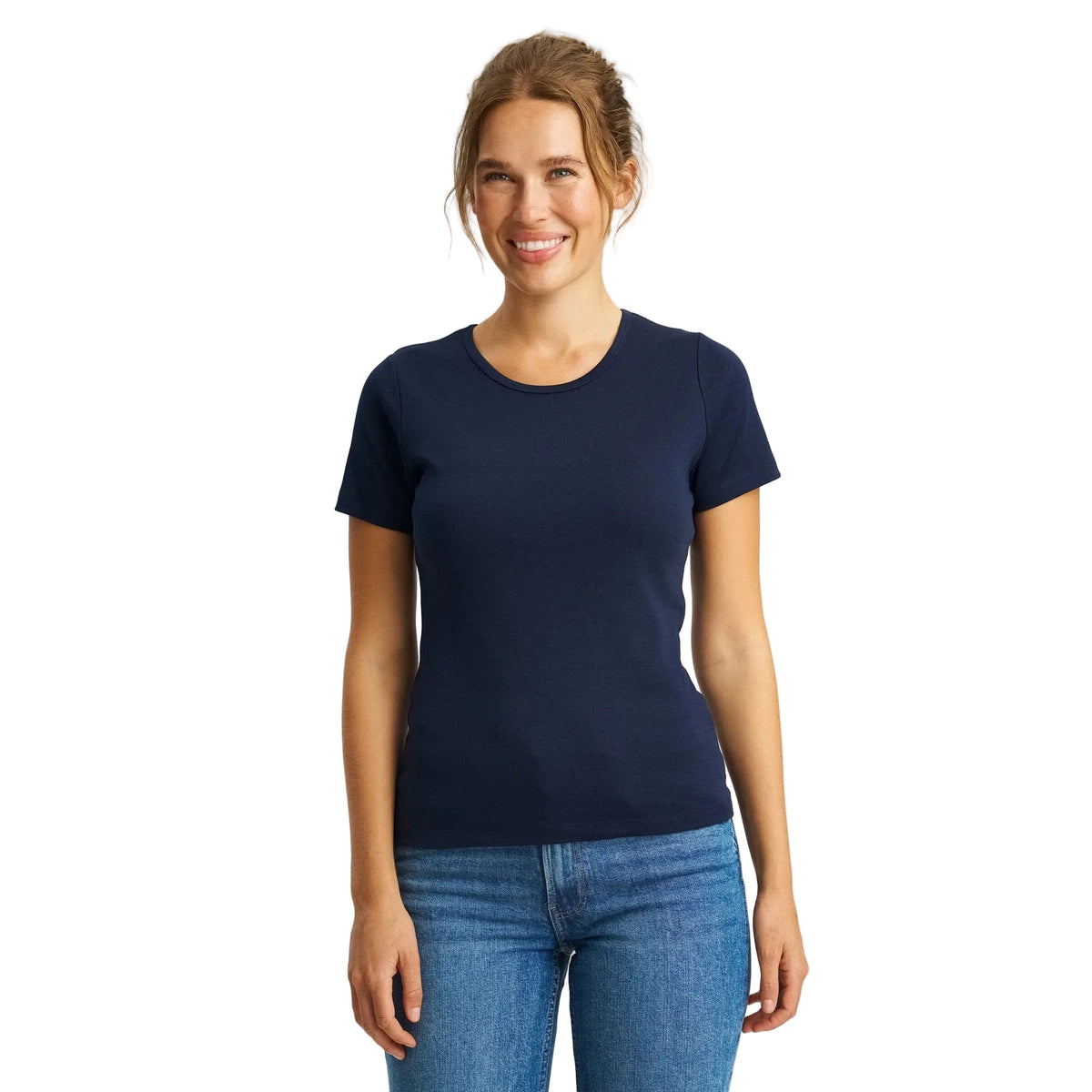 Woman wearing a navy blue t-shirt and blue jeans on a white background
