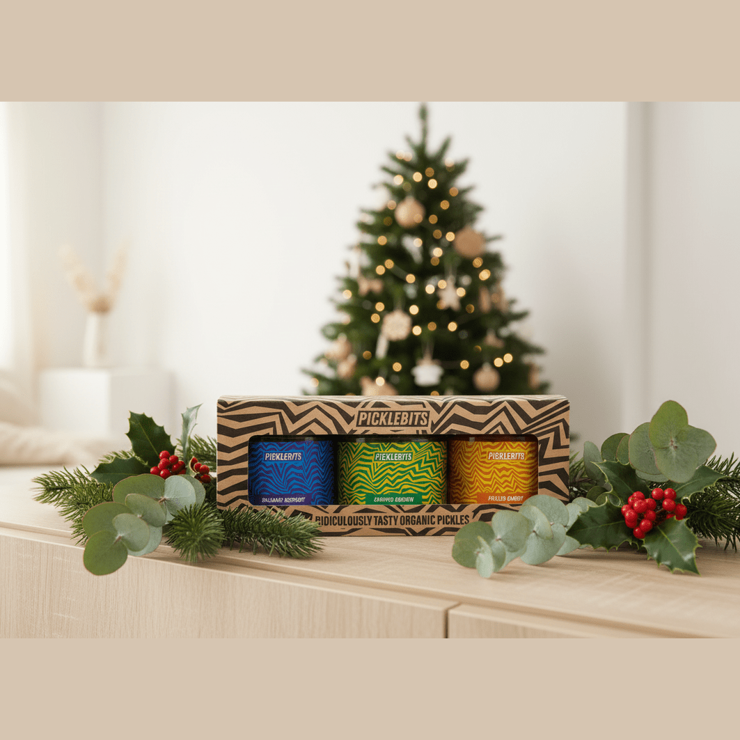 Box of Picklebits with a Christmas tree and decorations in the background