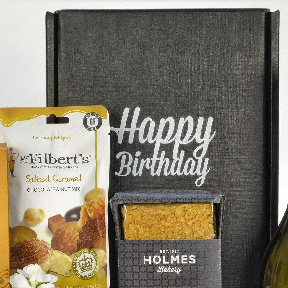 Gift box with 'Happy Birthday' message, Mr Filbert’s snack mix, and Holmes Bakery product.