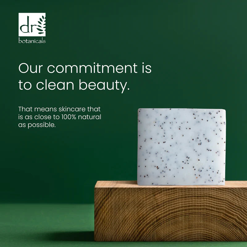 Soap bar on a wooden block with a green background and text about clean beauty and natural skincare.