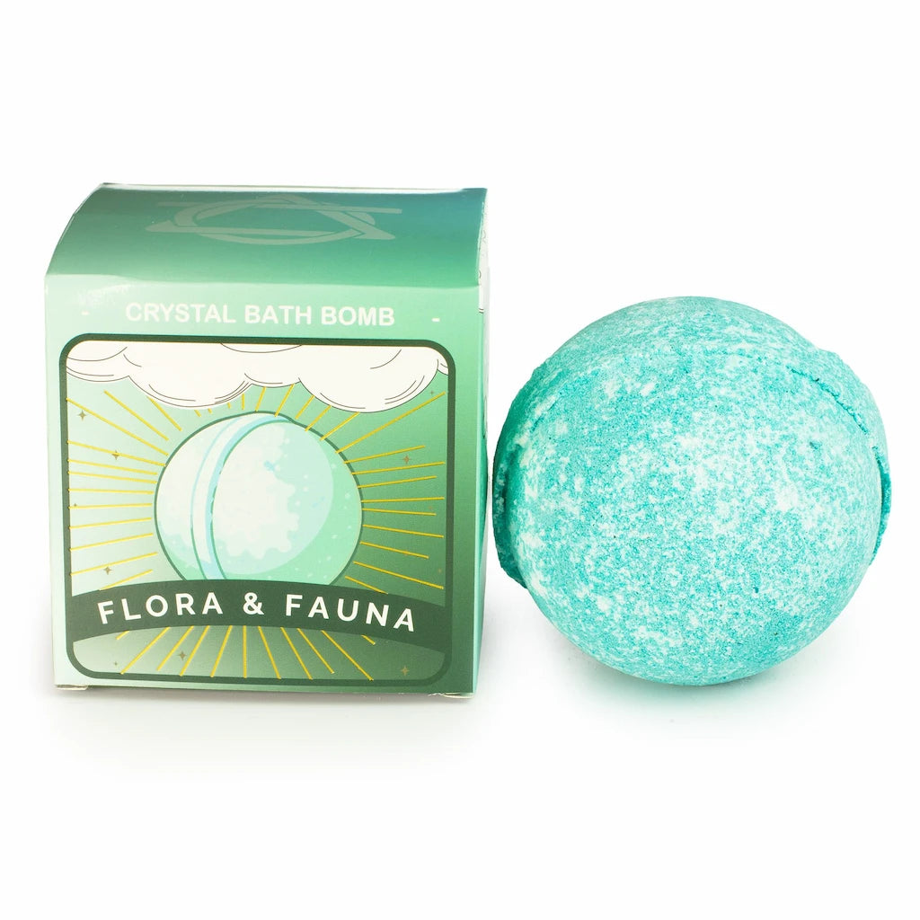 A turquoise bath bomb next to its green packaging box labeled 'CRYSTAL BATH BOMB' and 'FLORA & FAUNA' on a white background.