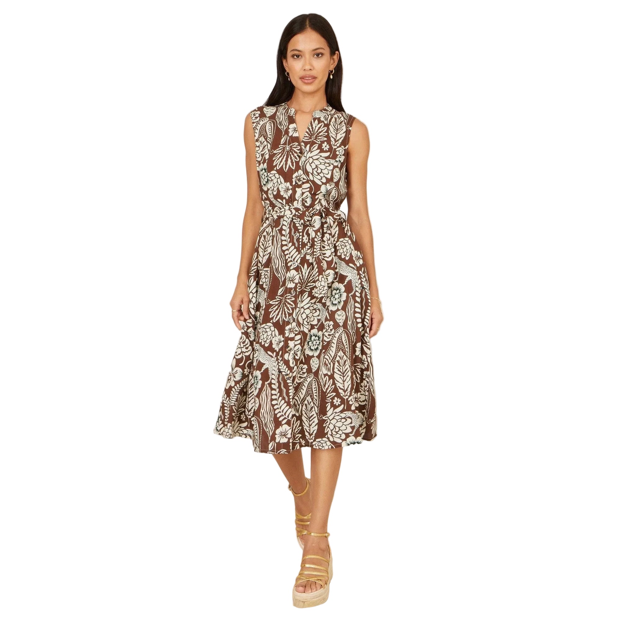 Woman wearing a patterned dress on a plain background