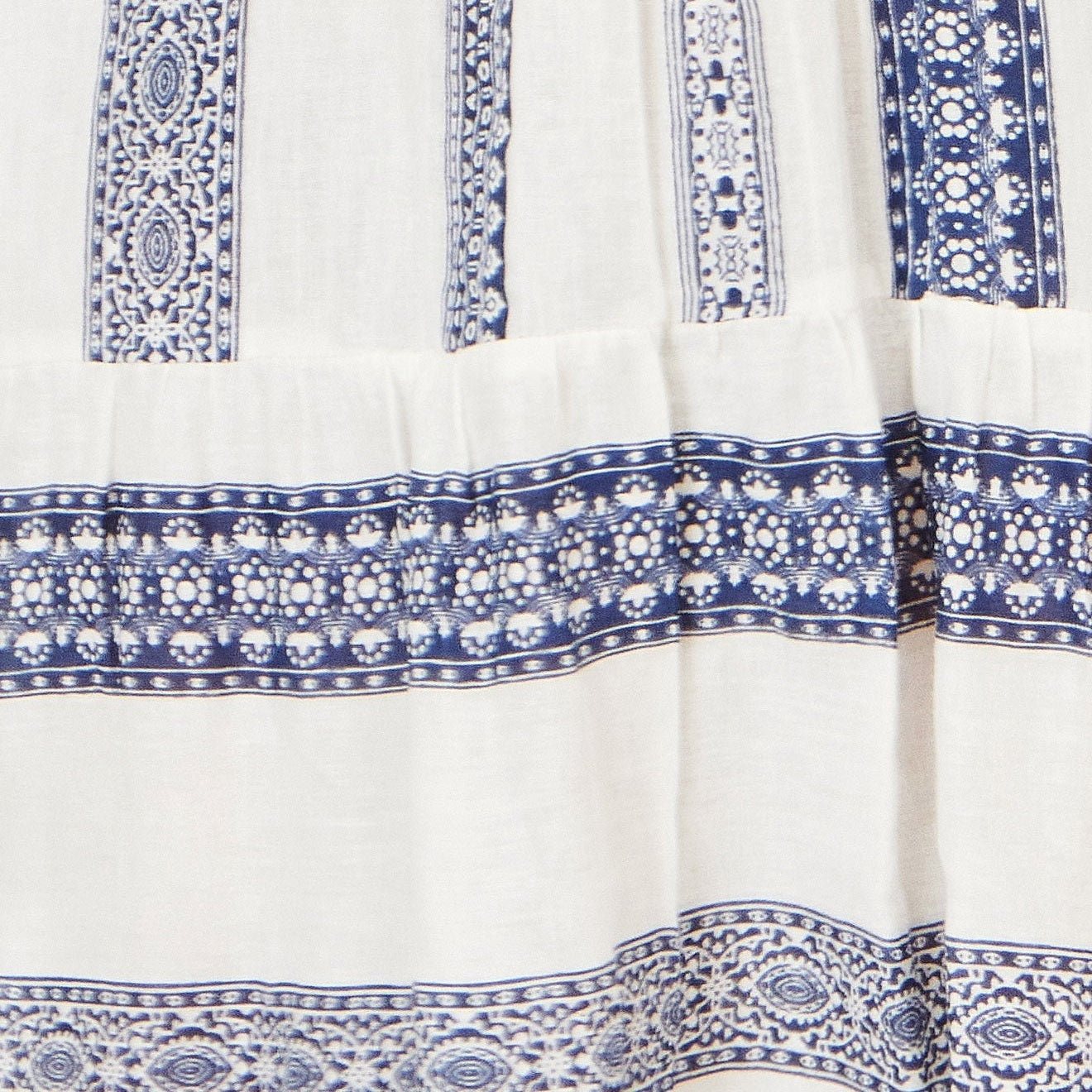 White fabric with blue and white geometric patterns