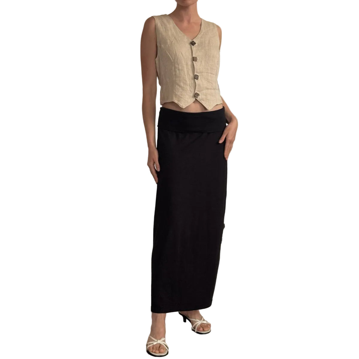 Woman wearing a beige sleeveless top and black skirt on a white background