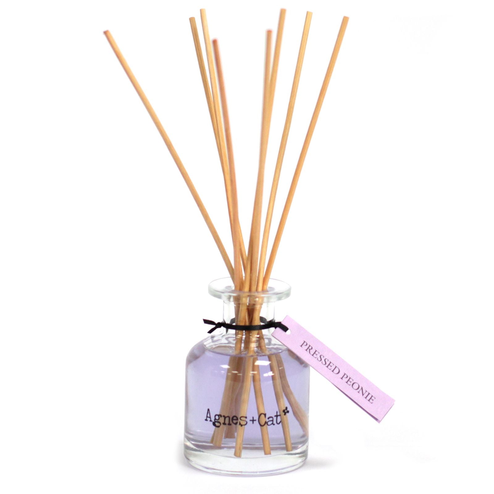 Elegant Pressed Peonies reed diffuser by Agnes + Cat, with a lavender glass bottle and black reeds.