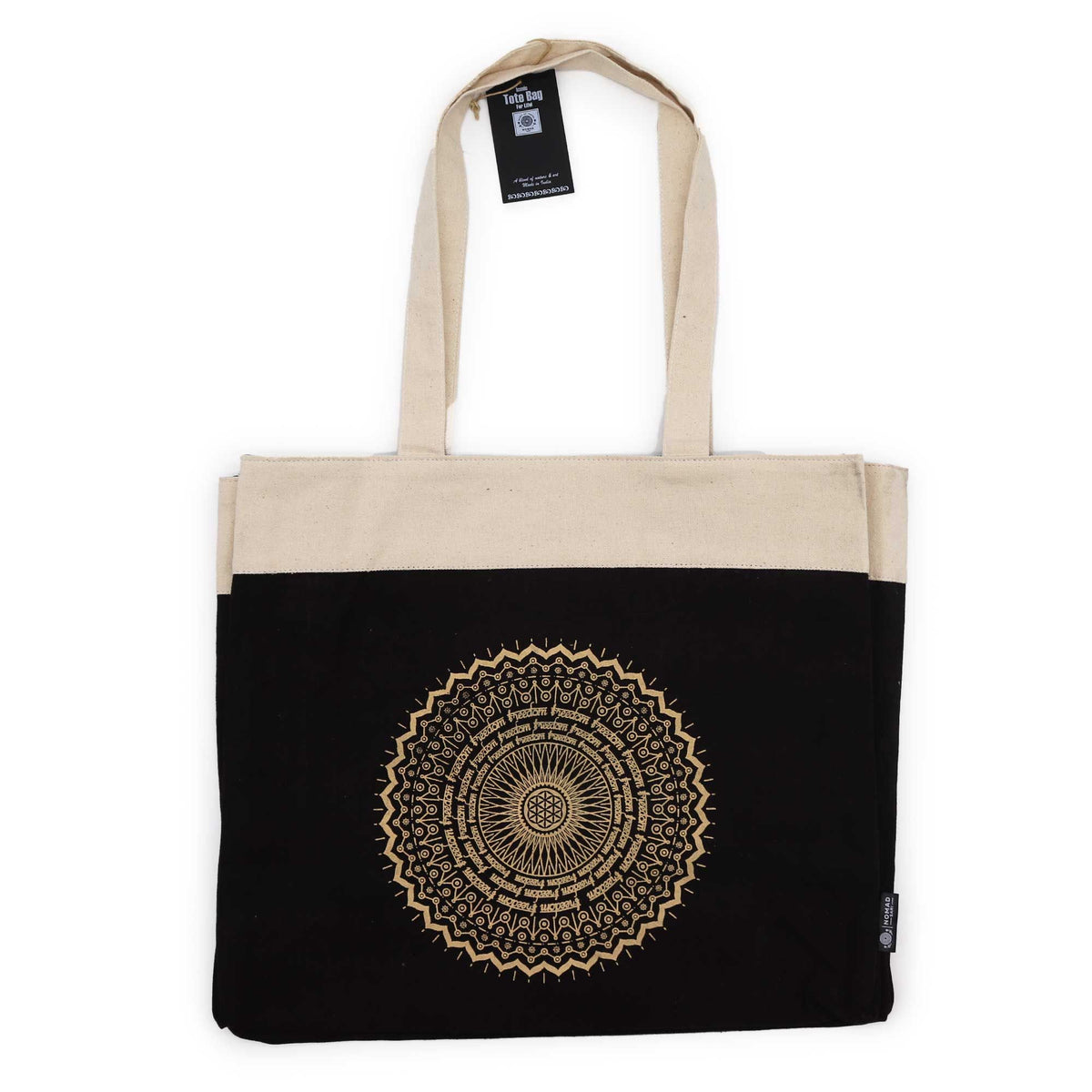 Tote bag with a black bottom half and a cream-coloured top half, featuring a mandala design.