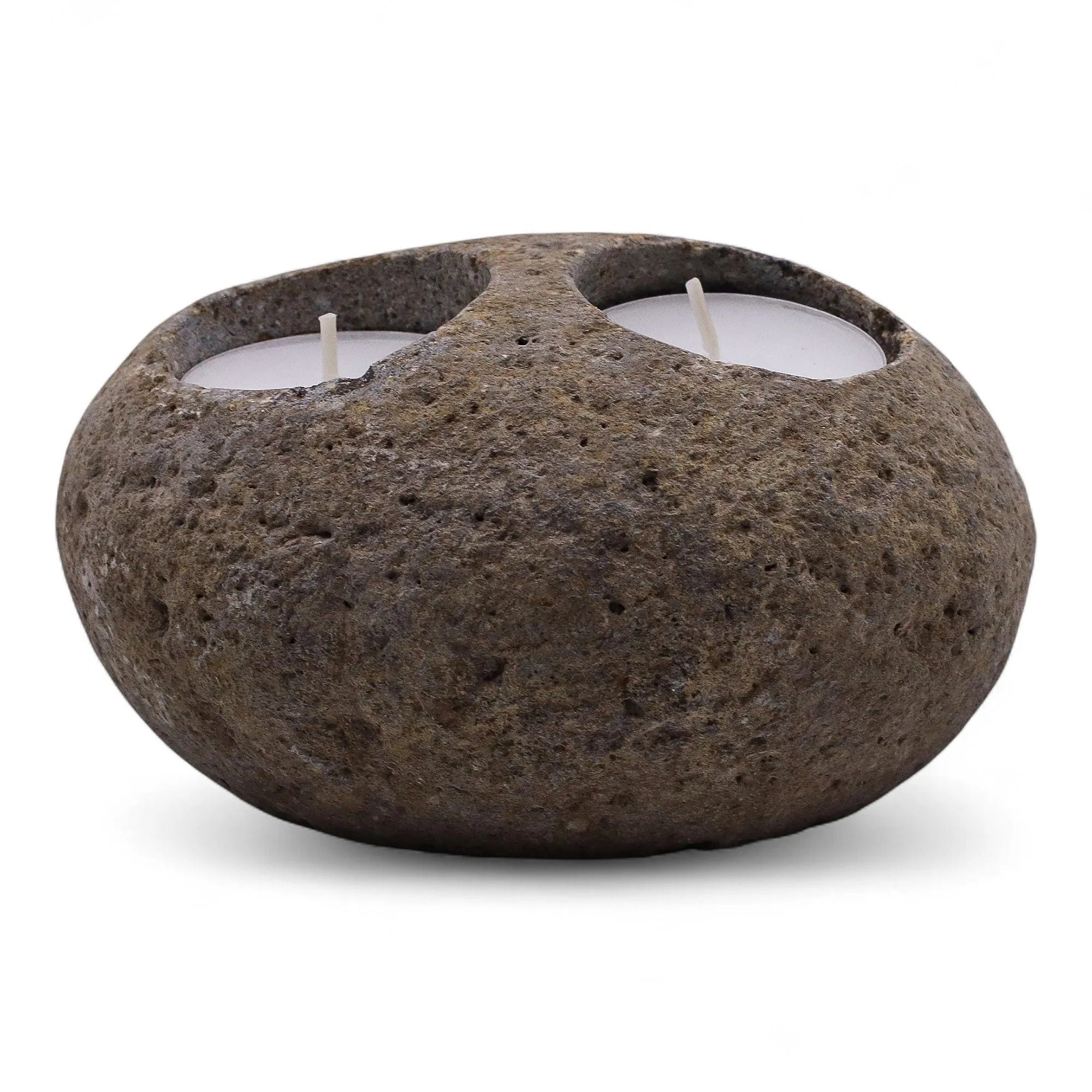 Rustic stone candle holder with two candles on a white background