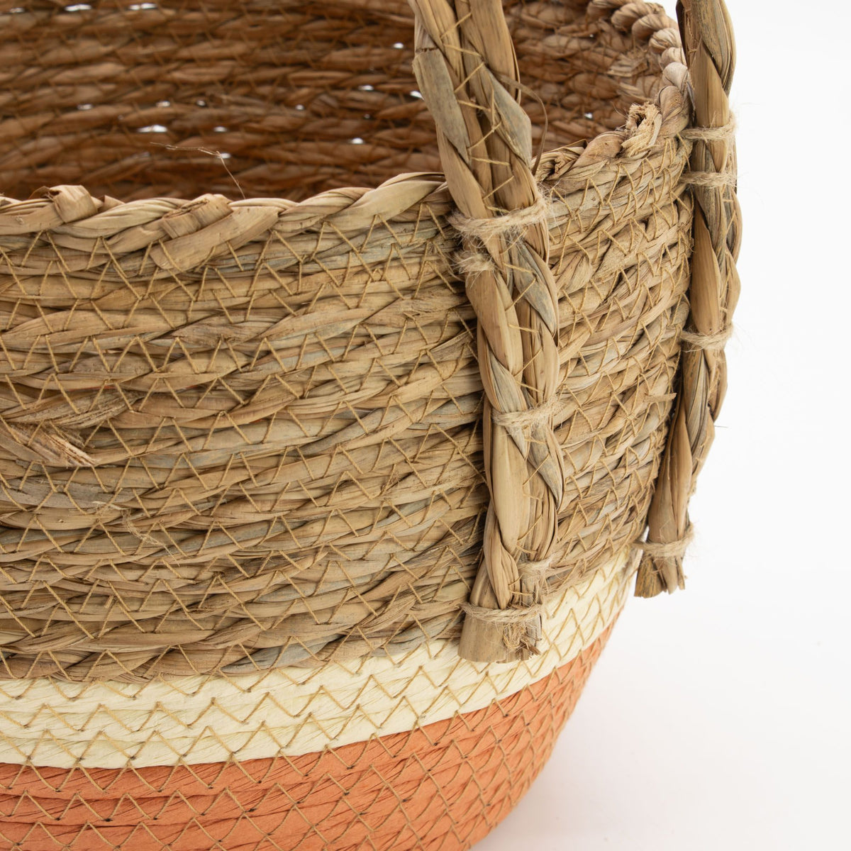 Close-up of the basket weave, handle attachment and pale band above the orange base