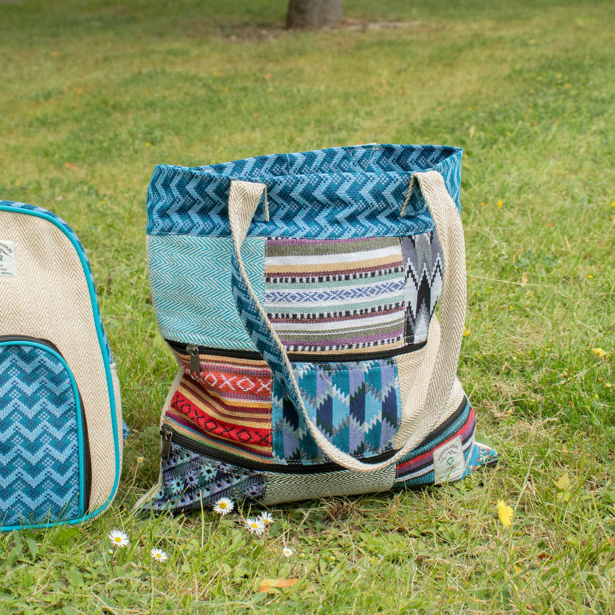 Multicolored patterned tote bag on grass