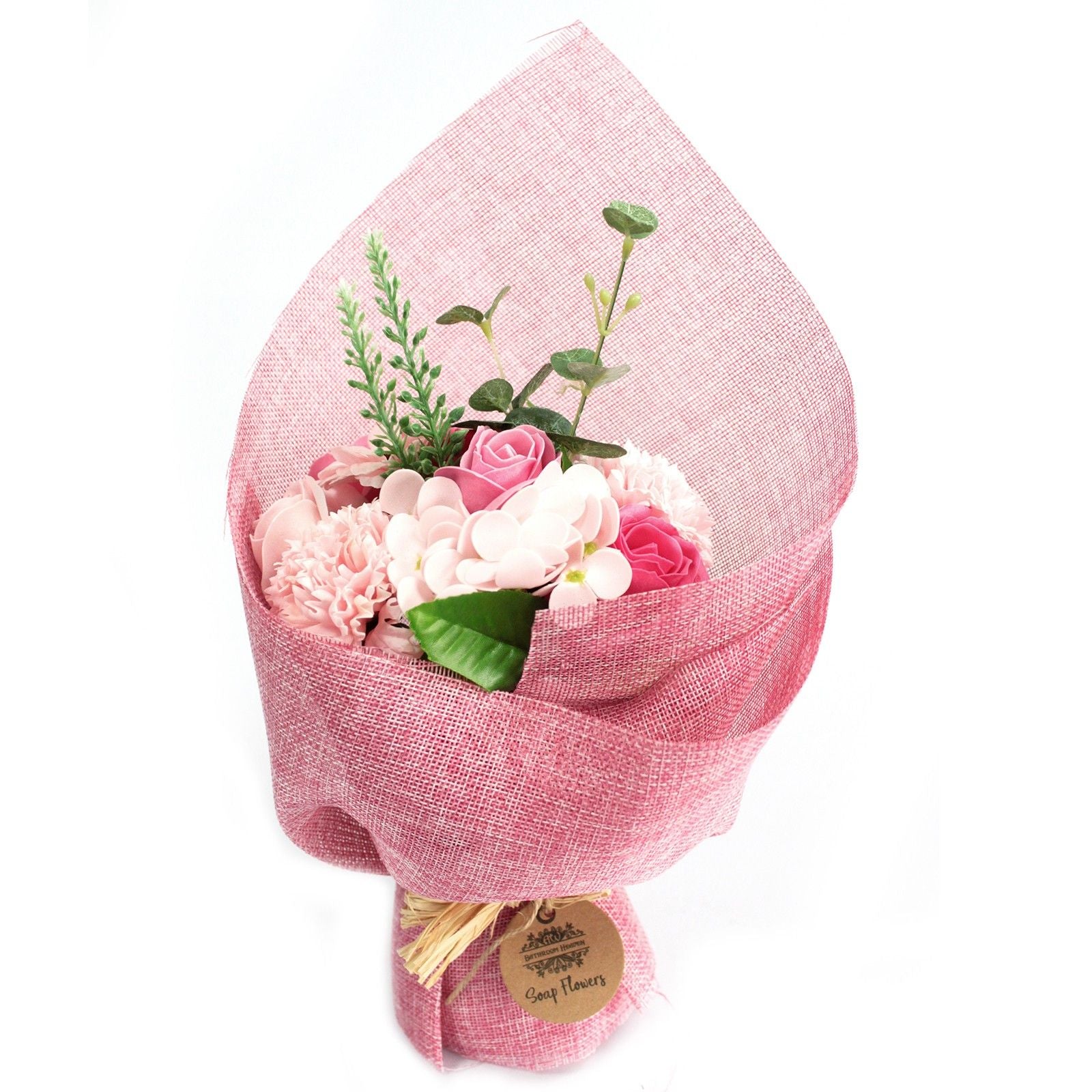 Bouquet of flowers wrapped in pink fabric with a visible brand tag on a white background