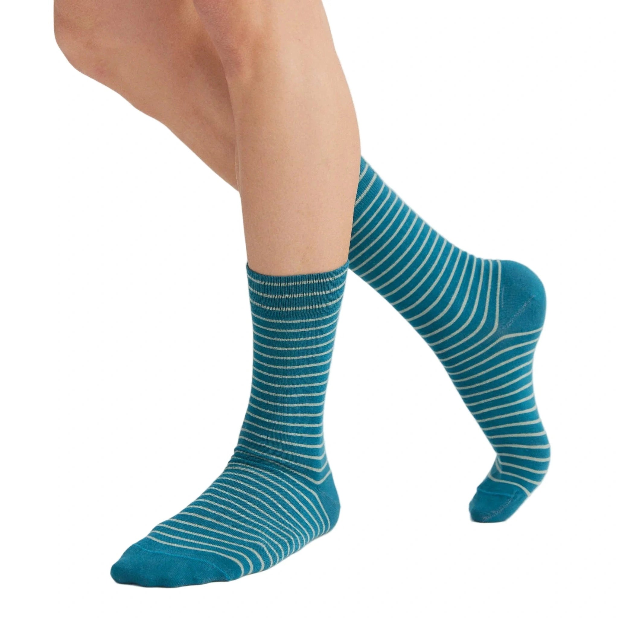 Teal striped socks worn by a person on a white background