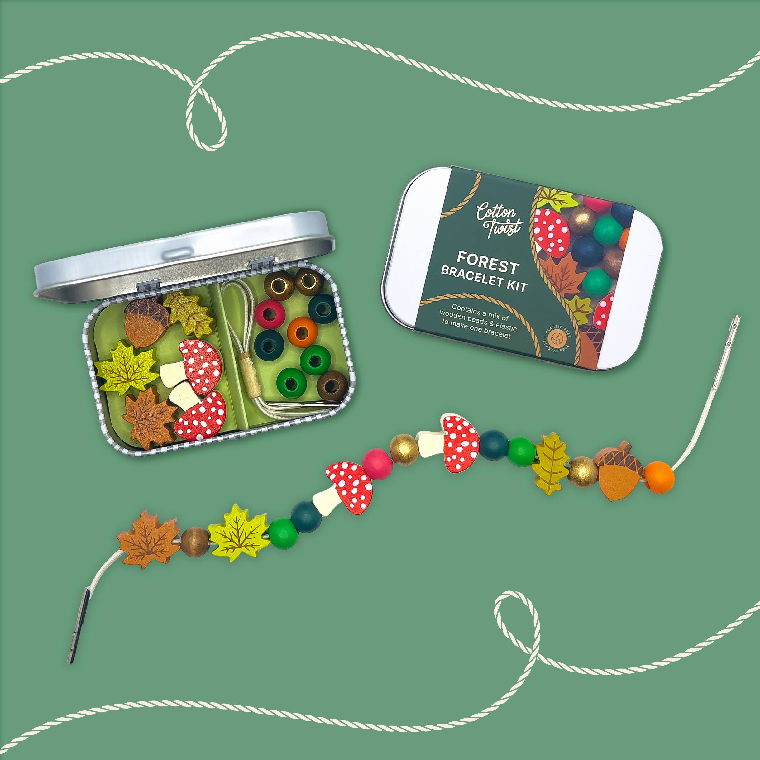 Forest-themed bracelet kit with open tin, bracelet, and packaging on a green background