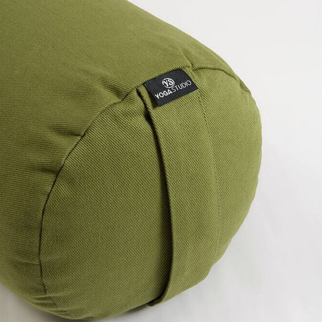 Green yoga bolster with a visible brand label on a white background