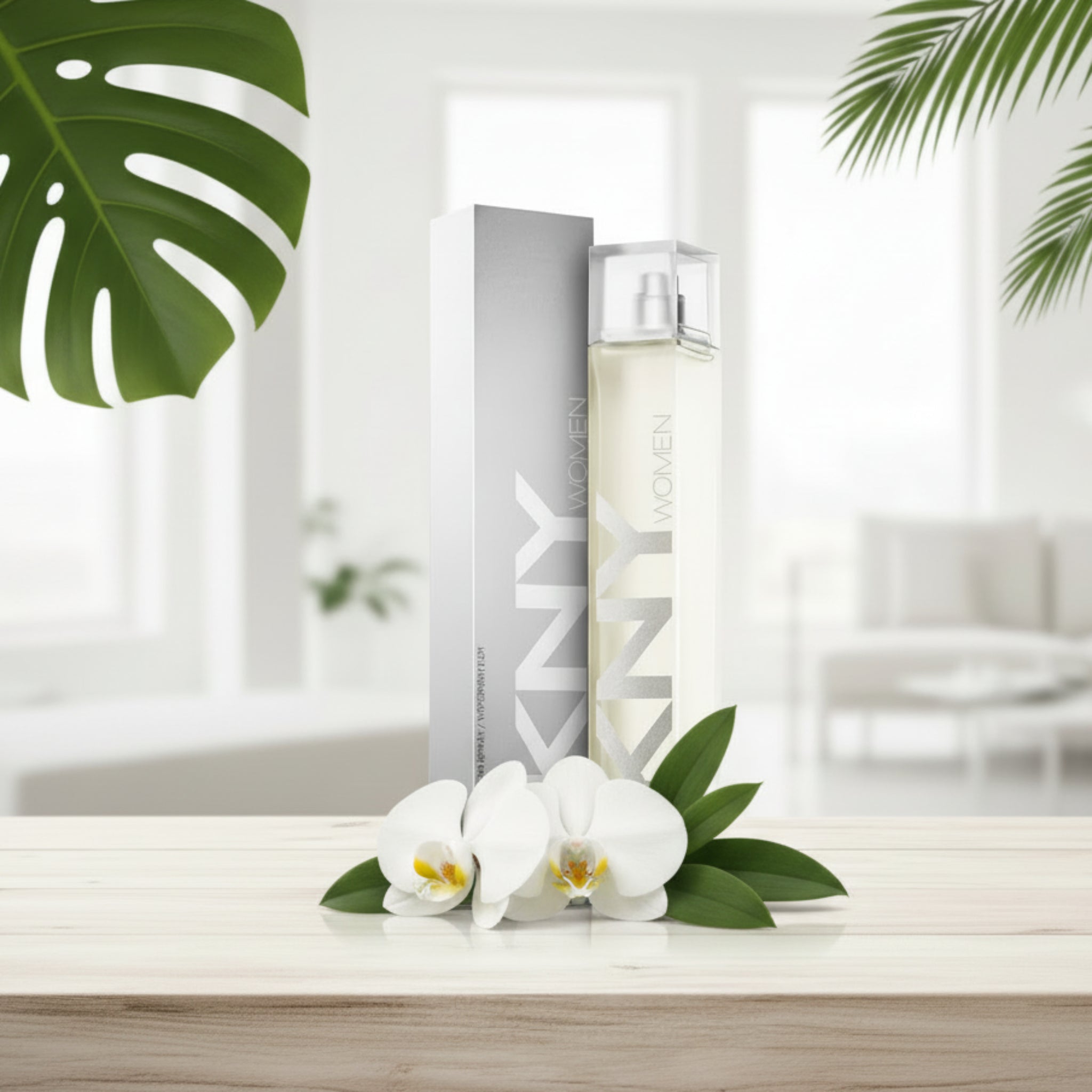 Two perfume bottles with 'DKNY' branding on a wooden surface with white flowers and green leaves.