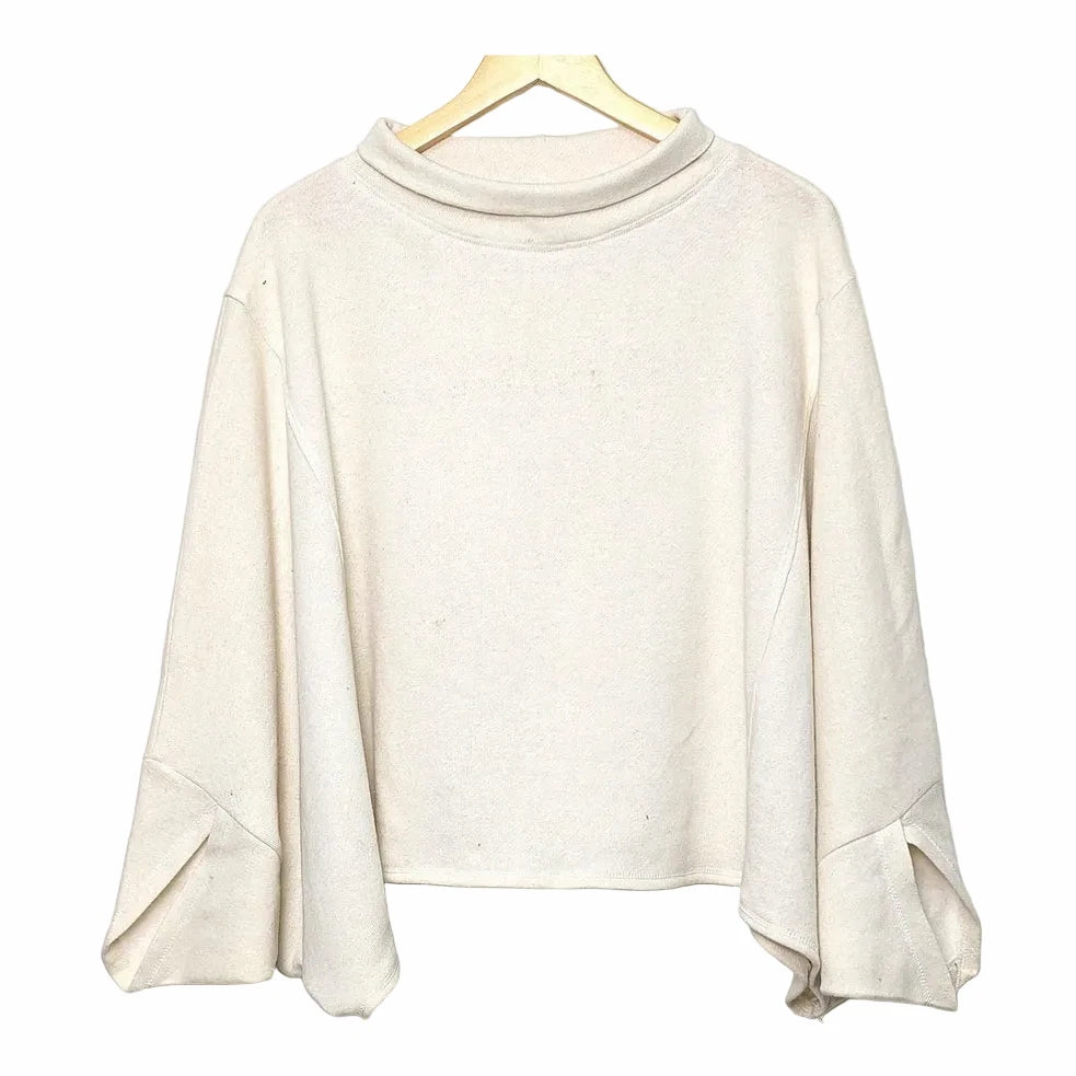 Beige sweater on a hanger against a white background