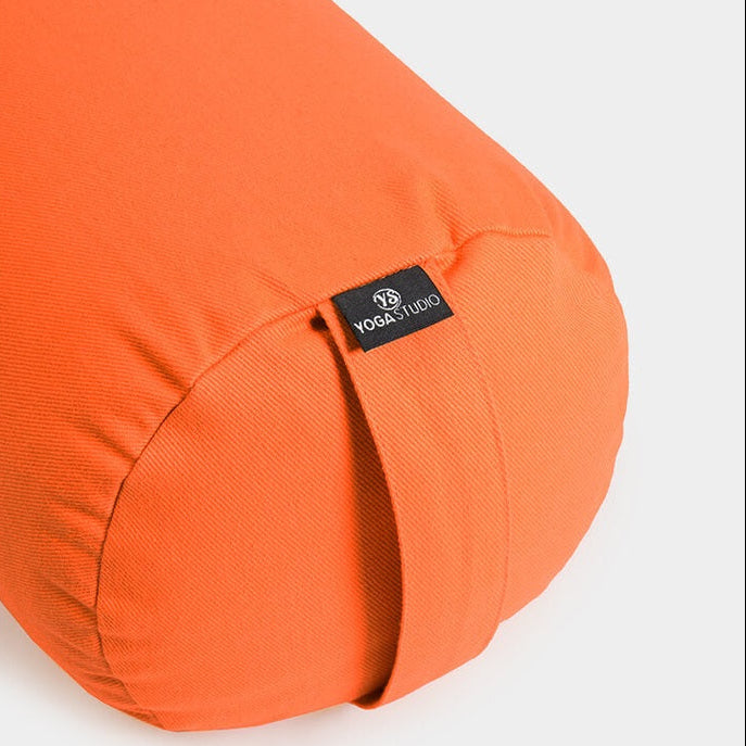 Orange yoga bolster with a visible brand label on a white background
