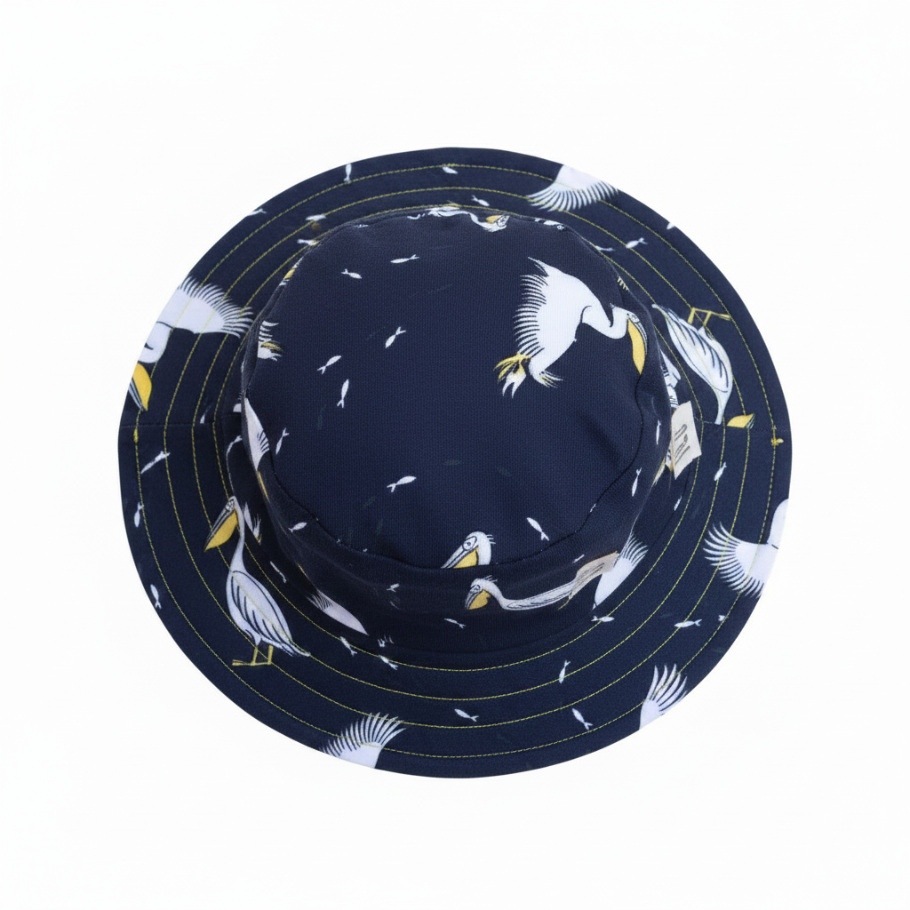 Blue pelican print reversible bucket hat flat lay on white background - ILO Clothing at Emmy Jane Boutique